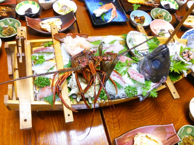 A platter of premium seafood featuring spiny lobster and abalone