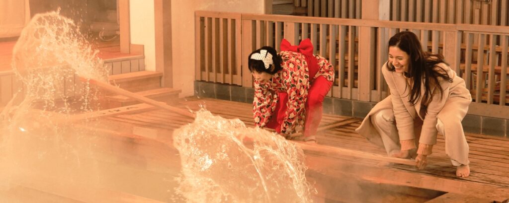 Tourists experiencing the “hot spring stirring” ritual